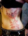 tribal phoenix pic tattoo on rib of girl